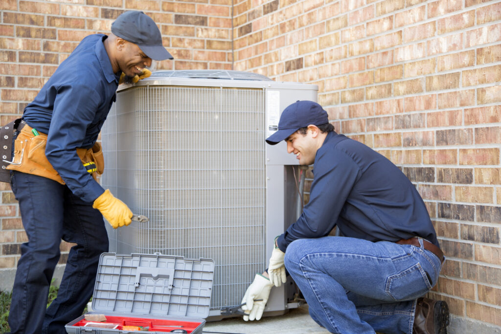 HVAC technicians installing new AC
